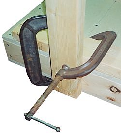 clamp leg square to worktop with a spacer underneath