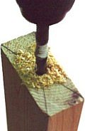 connect the corners of the bottom of the legs with lines.  the intersection marks the  center point.  drill perpendicularly to allow  for the threaded insert or T-nut